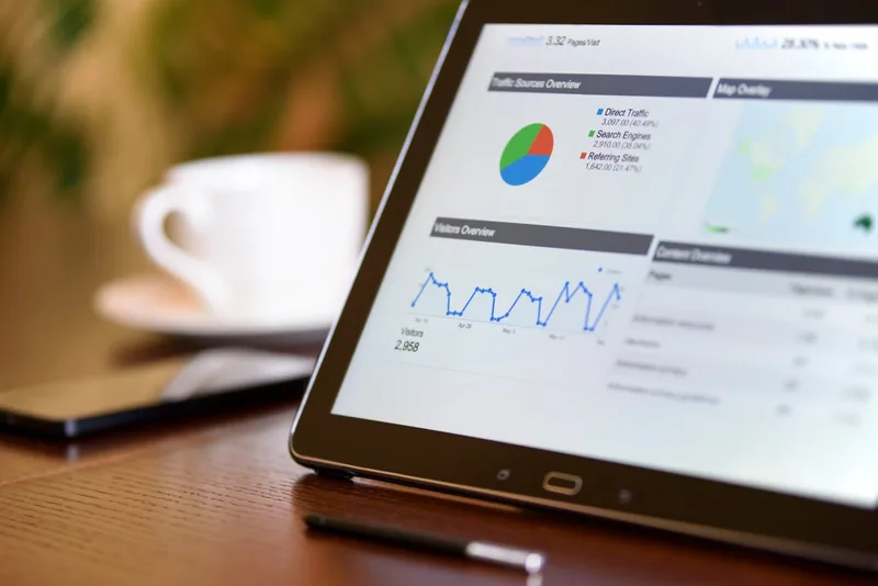 Website analytics graphs showing steady visitor traffic on a tablet